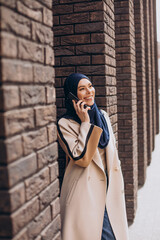 Modern muslim woman talking on the phone