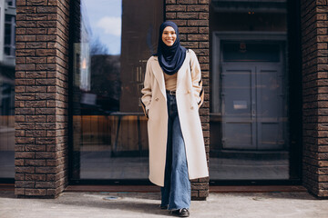 Young muslim woman student walking in the street