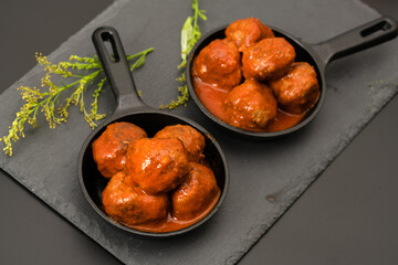 Meatballs in tomato sauce in a small frying pan