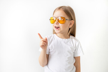 Portrait of a child girl in yellow glasses, white background