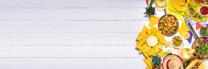 Cinco de mayo party food. Mexican holiday Cinco de mayo traditional dishes, snacks, tortilla corn chips, nachos, tacos, salsa, sauces. Friends and family feast background top view copy space