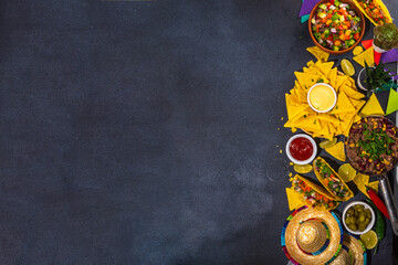 Cinco de mayo party food. Mexican holiday Cinco de mayo traditional dishes, snacks, tortilla corn chips, nachos, tacos, salsa, sauces. Friends and family feast background top view copy space