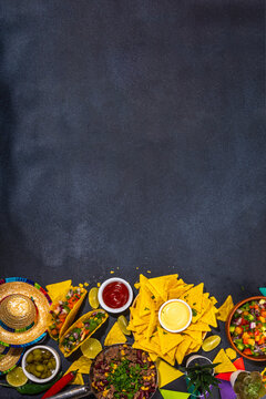 Cinco de mayo party food. Mexican holiday Cinco de mayo traditional dishes, snacks, tortilla corn chips, nachos, tacos, salsa, sauces. Friends and family feast background top view copy space