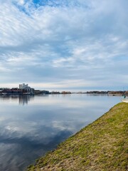 Sky reflection on the river surface, riverside, cloudy weather, natural river view