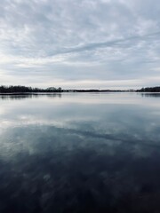 Sky reflection on the river surface, riverside, cloudy weather, natural river view