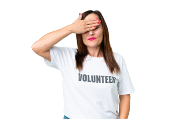 Middle age volunteer woman over isolated chroma key background covering eyes by hands. Do not want to see something
