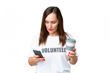 Middle age volunteer woman over isolated chroma key background holding coffee to take away and a mobile
