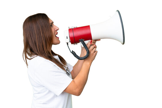 Middle age volunteer woman over isolated chroma key background shouting through a megaphone