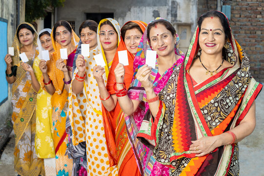 Group of happy traditional indian women wearing sari standing in queue showing blank id card. Equality, Ethnicity. Election india. Womon rights. 
