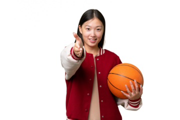 Young basketball player asian woman over isolated background shaking hands for closing a good deal