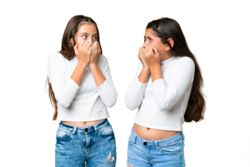 Friends girls holding gift and a birthday cake over isolated chroma key background is a little bit nervous and scared putting hands to mouth