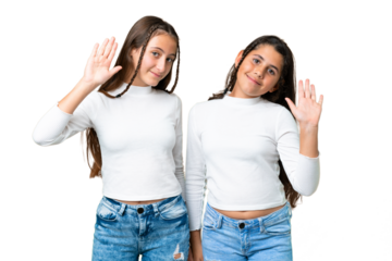 Friends girls holding gift and a birthday cake over isolated chroma key background saluting with hand with happy expression