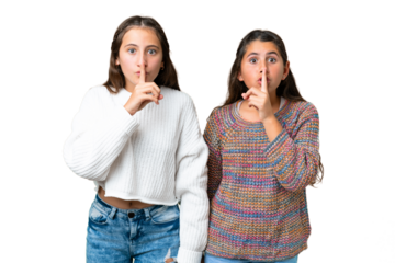 Friends girls over isolated chroma key background showing a sign of closing mouth and silence gesture