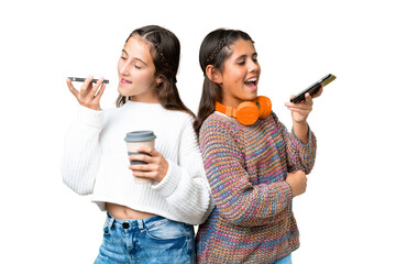 Friends girls over isolated chroma key background sending a message voice or email with the mobile