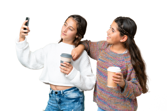 Friends girls over isolated chroma key background making a selfie with the mobile