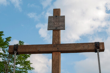 Christian cross carved on a rock. Cross carved on a rock in the mountains
