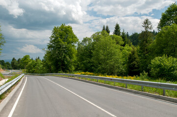 highways in the mountains against the background of the sunny sky and the white clouds