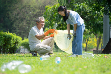 grandfather support granddaughter to collect plastic garbage,sorting plastic bottles waste in the...