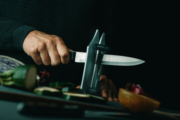 man sharpening a kitchen knife