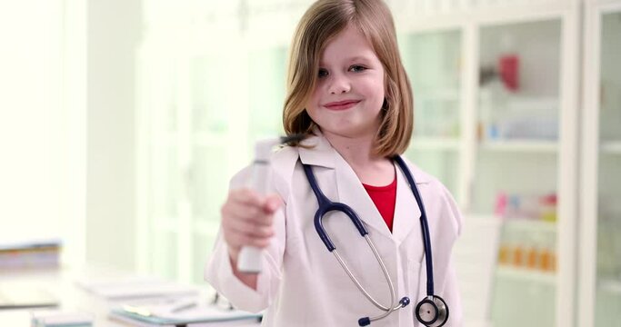 Little girl in the uniform of a doctor and an otoscope, close-up. Playing in the clinic, ENT, shallow focus
