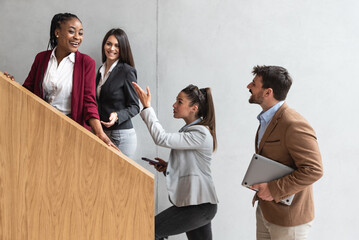 Group of happy business people walking in office building. Colleagues talking strategy, ideas for business advance and prosperity of company research in the future. Planning and investing