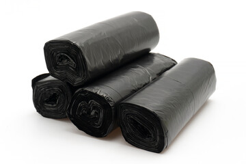 Stack of Unused Black Plastic Trash Bags (Rolls) with Handles on Plain White Background
