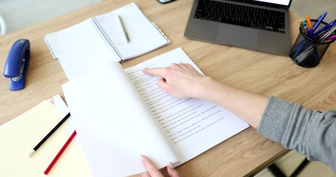 A woman in the office reads a script on paper, a close-up. Sales funnel, lead conversion, slowmotion