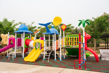 Children playground on yard activities in the school.Outdoor play equipment for kindergarten children.Children run, slide, swing,seesaw on modern playground.Colorful playground on yard in the park.