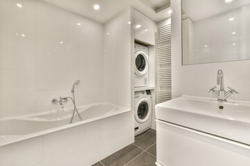 a laundry room with two sinks and a washer in the corner next to the sink is a washing machine