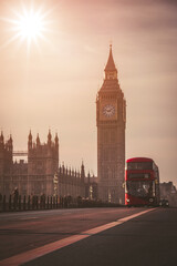 Fototapeta na wymiar Red London Bus on the Westminster Bridge and Big Ben Tower in the background.