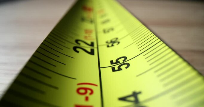 The numbers on the yellow meter of roulette, close-up. Measuring tool. Construction bright tape