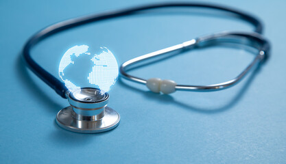 Stethoscope with a globe on the blue background.