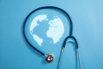 Stethoscope with a globe on the blue background.
