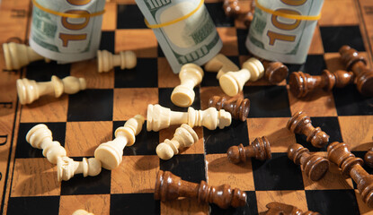 Chess figures and dollar money on the chessboard.