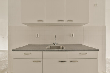 a kitchen with white cabinets and gray counter tops on the counters in this photo is taken from above, looking down at the sink