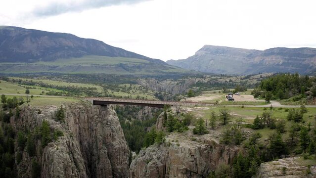 Drone view of rough mountain cliffs connected with a bridge in Wyoming, United States