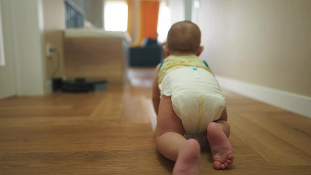baby newborn crawling on the floor. happy family kindergarten kid concept. First steps, baby crawling view from the back. baby learns to crawl to explore the world dream. first steps creeps lifestyle