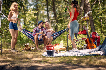 camping, tourism and travel concept -  friends  have good time on camping trip