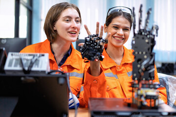 Girl engineer in robot industry fabrication research room simulate testing robot arm on operation