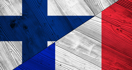 Background with flag of Finland and France on divided wooden board. 3d illustration