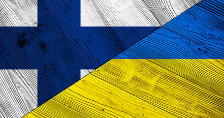 Background with flag of Finland and Ukraine on split wooden table. 3d illustration
