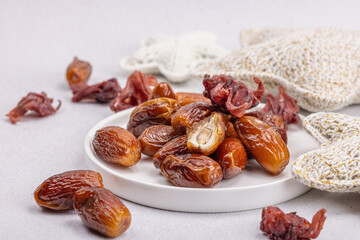 Ripe dates, traditional Ramadan Kareem concept snack for Iftar or Suhoor meal on a light background