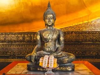 Foto op Plexiglas Historisch monument Close up view of a Golden Buddha statue standing in Wat Pho at Bangkok, Thailand