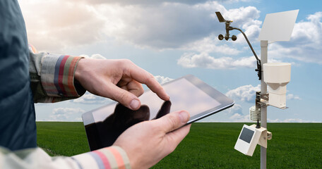 Farmer control weather station via digital tablet. Precision and smart farming equipment	