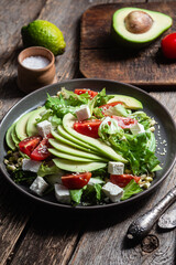 Salad with feta cheese, avocado and tomatoes in a bowl