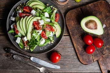 Salad with feta cheese, avocado and tomatoes in a bowl