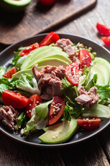 Salad with tuna, avocado and tomatoes in a bowl