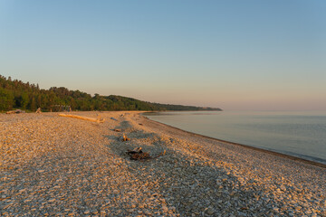 Pebble beach in Toila oru, Estonia. A sunny evening on the coast of the Gulf of Finland. Natural background. Space for text.