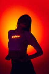 Portrait with sexy female silhouette and digital neon filter lights with inscryption on body on gradient red mode background. Erace from mind