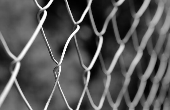 Chain link metallic fence black and white image